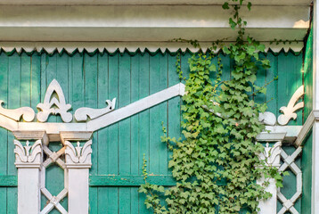 Green old facade made of painted green boards