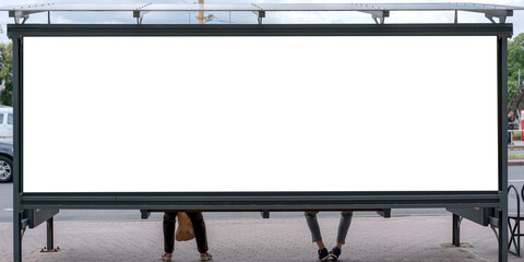 rear view of urban bus stop with large white blank advertising poster sign in metal black frame