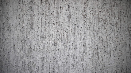Grey grunge textured wall. White old cement concrete background. Surface of plaster, stucco. Rough cracked texture. Close up, top view