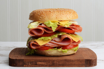 closeup ham cheese tomato lettuce bagel sandwich