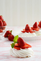 closeup of strawberries meringue nests with mint