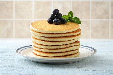 closeup stack of pancakes with blueberries and mint