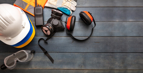 Work safety protection equipment. flat lay on wooden background.