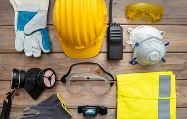 Work safety protection equipment. flat lay on wooden background.