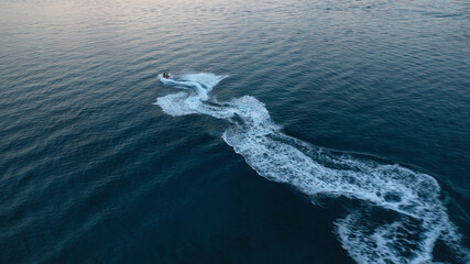 defaultAerial drone photo of stunt man performing extreme stunts with water craft over the ocean at...