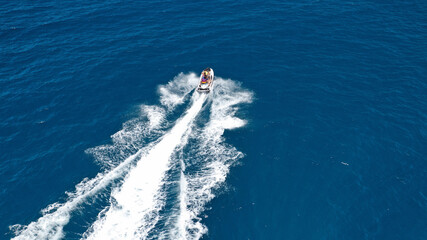 Obraz premium defaultAerial drone photo of stunt man performing extreme stunts with water craft over the ocean at dusk