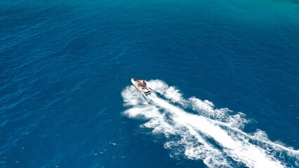 defaultAerial drone photo of stunt man performing extreme stunts with water craft over the ocean at...