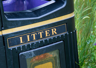 Coastal walk blue litter bin with purple lining and gold lettering.