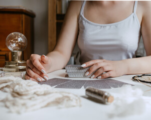 woman holding in her hands tarot cards