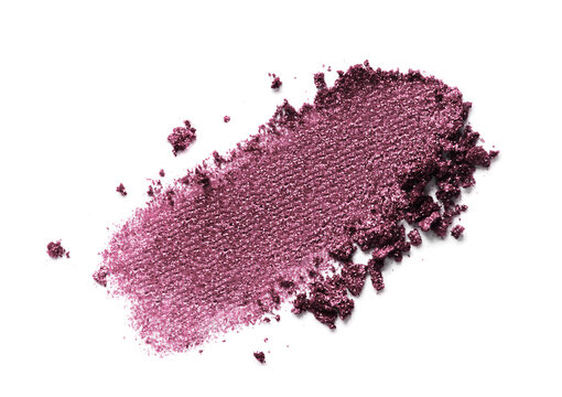 Eyeshadow swatch isolated on white background. Glitter makeup smear smudge. Plum purple color shimmer eye shadow powder texture