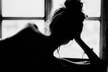 Naked woman near the window