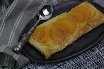 Pear Tart on Black Plate, White background