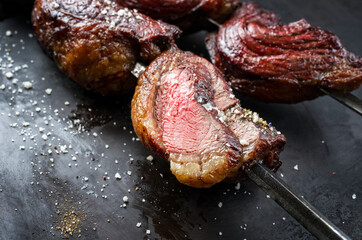 Barbecue dry aged wagyu Brazilian picanha from the sirloin cap of rump beef offered on a skewer on...