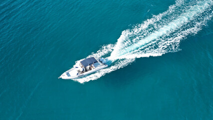 Aerial drone ultra wide photo of rigid inflatable speed boat cruising in deep blue Aegean sea,...