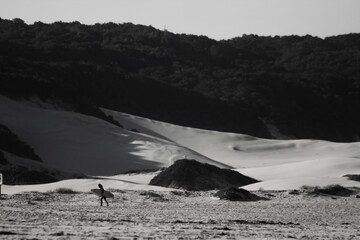 Surfer walking on the beach