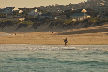 Surfers walking on the beach