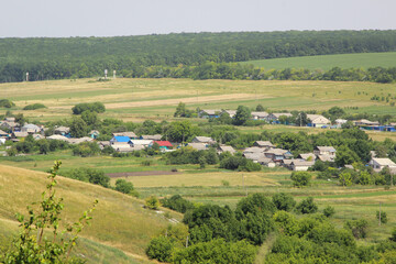 Fototapeta na wymiar Beautiful view of a Russian village from the hill. Lovely little houses.