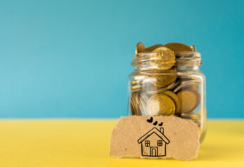 A jar of coin, saving money for house concept