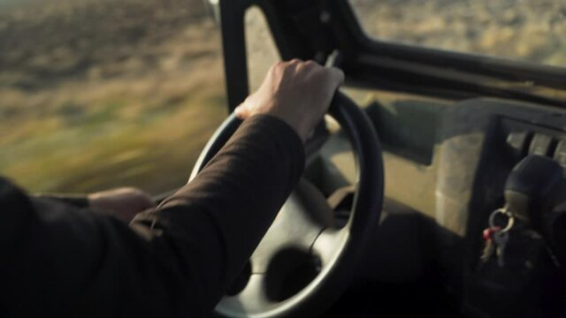 travels ringer in farmers fields, 
Close up steering wheel