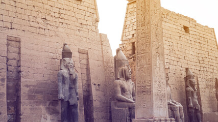 obelisk column at Luxor temple entrance with pharoah scultures