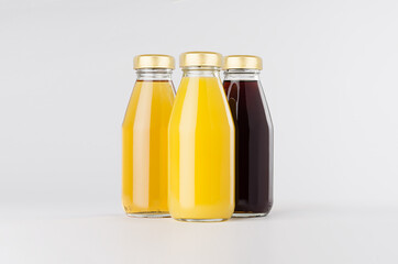 Yellow, red fruit and berries juices collection in glass bottles with cap, group mock up on white background, template for packaging, advertising, design product, branding.