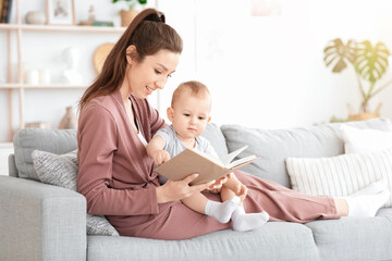 Caring Mom Reading Book Aloud To Her Adorable Baby Boy At Home