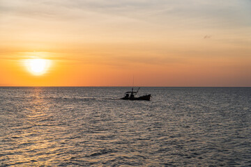 Fototapeta na wymiar fishing boat at sunset