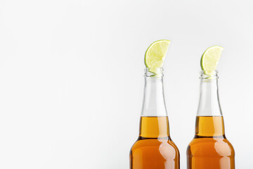 Beer with lemon. Bright lager in bottles isolated on white background