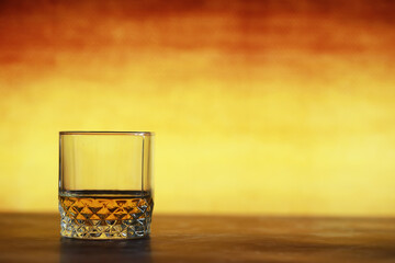 A glass of hard alcohol with ice on a bar counter. Whiskey with soda in a glass. Advertising alcoholic drink.