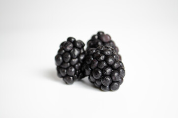 Fresh blacberries organised in group covered with water drops