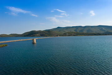 Fototapeta na wymiar aerial view of the ancient spanish mill in the wester lagoon in Orbetello and in the background the monte argentario