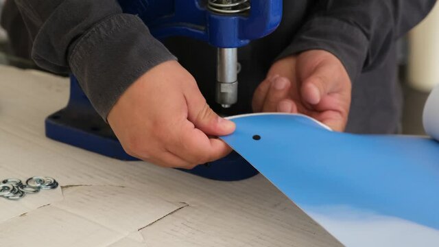People using eyelet machine
