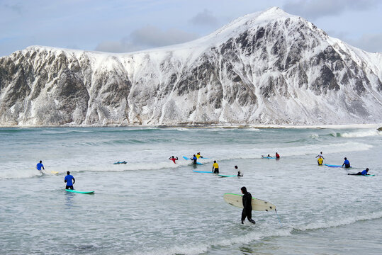  Surfing in arctic conditions at Flakstag Beach, Lofoten, Norway, Europe