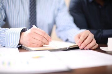 business people and lawyers discussing contract papers sitting at the table. Concepts of law, advice, legal services.