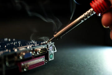 smoking soldering iron on dark background with copy space