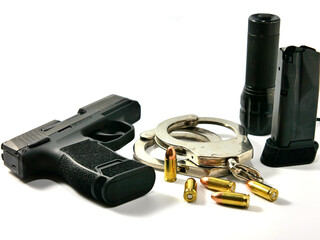 Short guns, ammunition, flashlight and handcuffs placed on white background.Guns, ammunition, flashlight and handcuffs are ready to use.