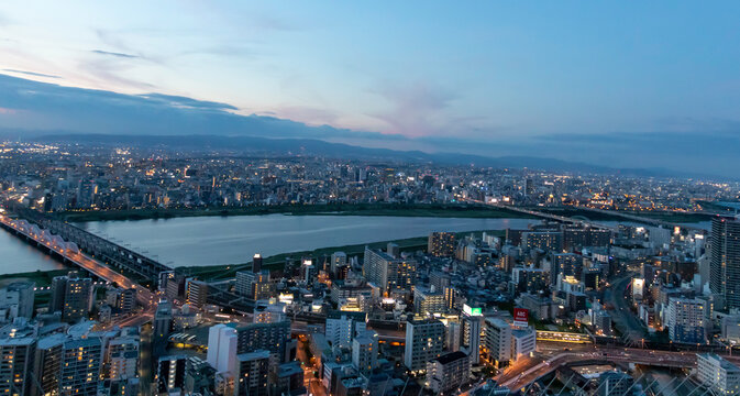 High-rise buildings in the middle of Osaka with spectacular sunset colors. Umeda district aerial view. Osaka cityscape, Japan.