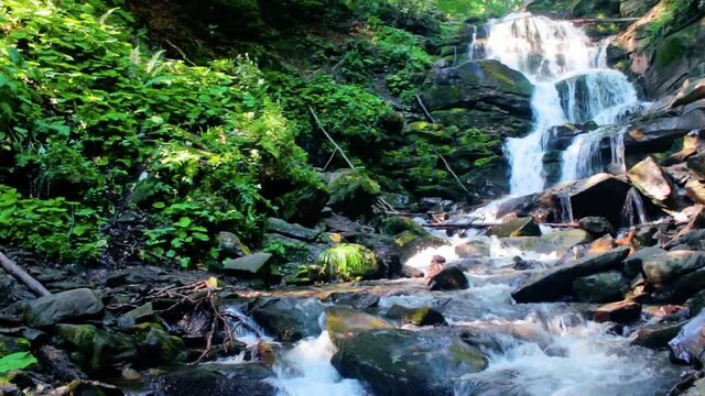 great water fall in the forest. beautiful nature landscape. river among the rocks. fresh summer scenery