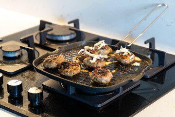 Cooking and Frying Meatballs in Pan / Turkish Kofte or kofta with Melted Cheese at Kitchen.