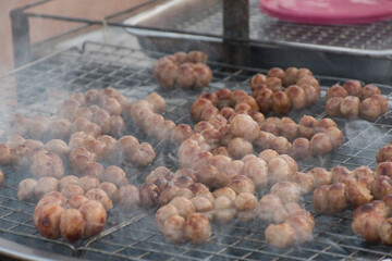 Isaan sausages on the grill grill with smoke up