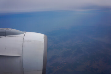 jet plane window sky view with machine wing in the morning.