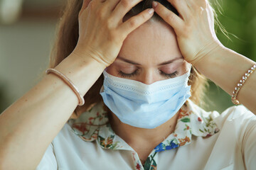 stressed stylish woman in white blouse with medical mask