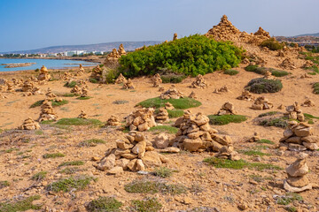 Cyprus. Aphrodite trail Cape Cavo Greco. Landscape near Cape Aphrodite. Pebbles stacked on top of...