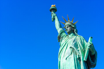 Statue of Liberty on a background of blue sky. Symbol of freedom of the USA. Symbols of the United States of America.