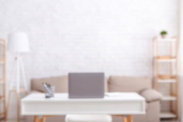 Workplace at home. Notebook and stationery on white table in interior