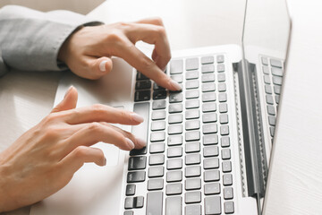 Female Hands Typing Text On The Keyboard Of Laptop at Office .