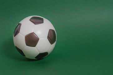 Soccer ball on a green background with copy space. football matches.