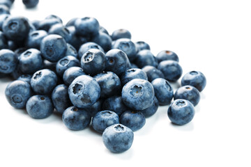 Blueberries are scattered on a white background. Free space, isolate. Studio light.