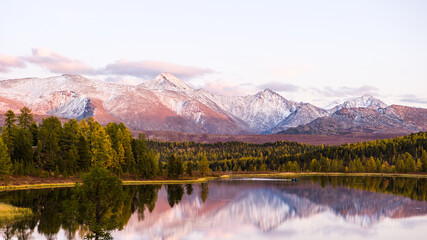 Lake Cicely Altai, Siberia, pink sunset over a lake and mountains in autumn day. Taiga, beautiful...
