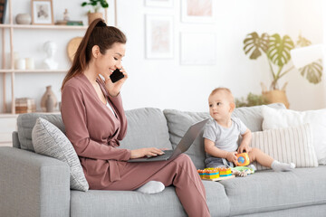 Busy Mom Working With Laptop And Cellphone While Taking Care Of Baby